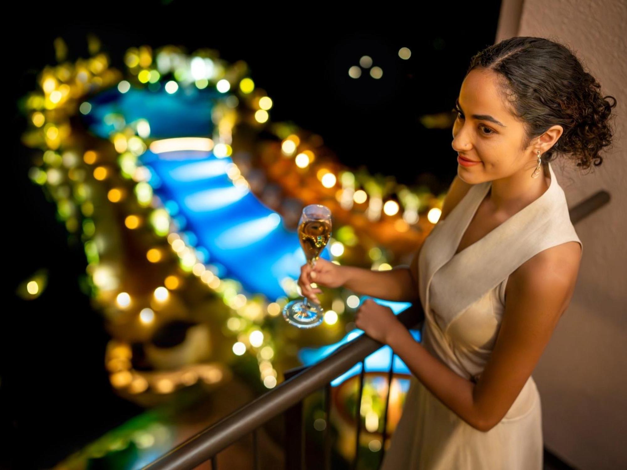 Oriental Hotel Okinawa Resort & Spa Nago Exterior photo A woman holding a glass of champagne